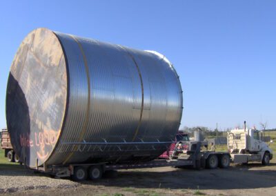 Custom truck equipment helping transport a large bin.