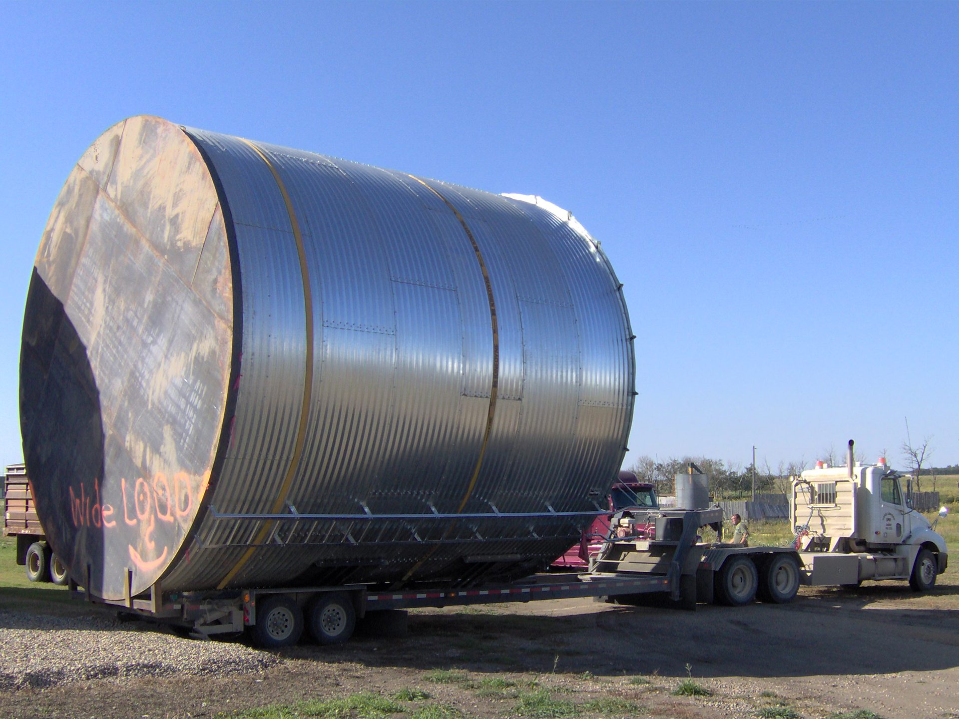 Custom truck equipment helping transport a large bin.