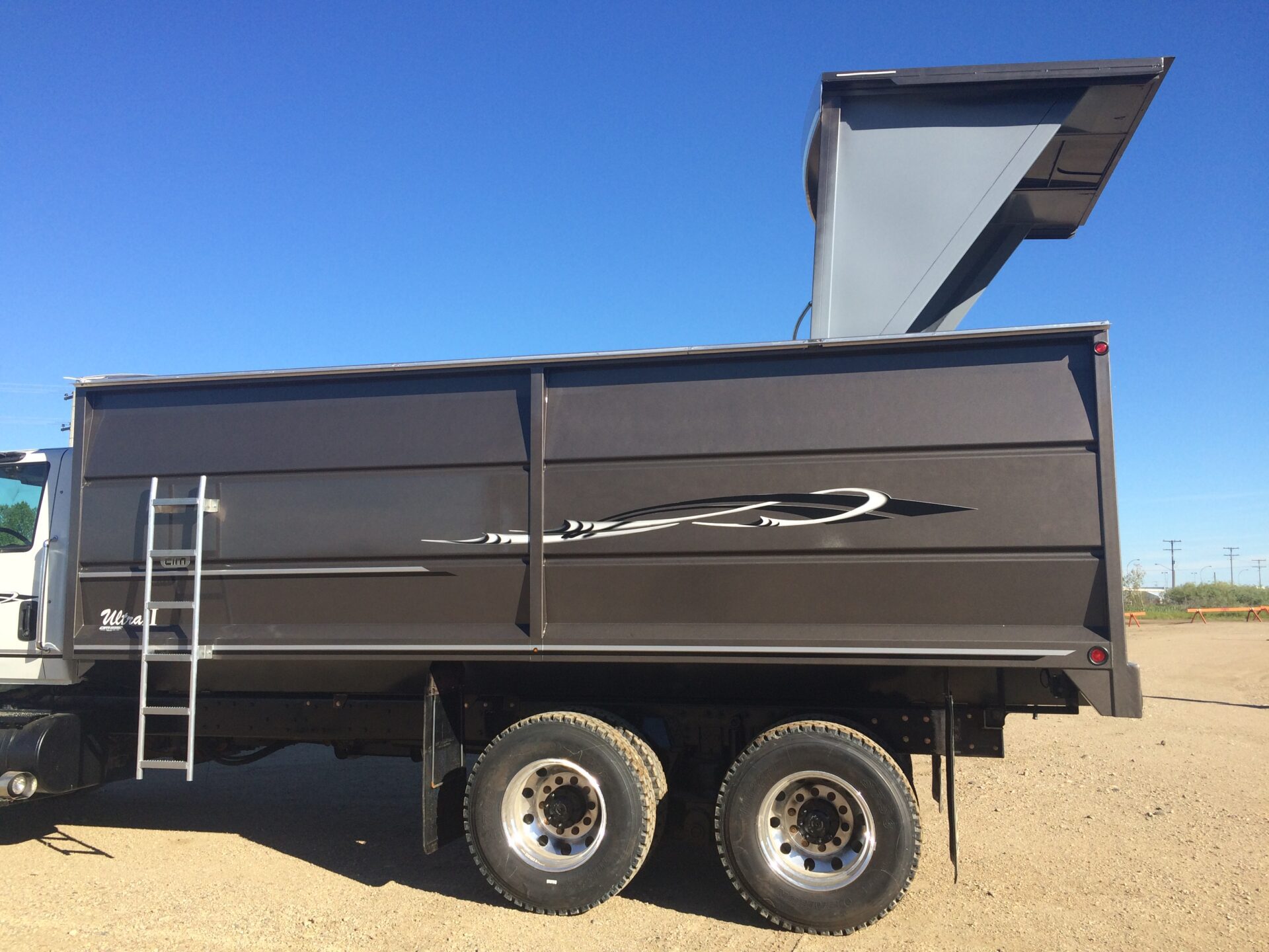 A custom grain trailer with hatch extended for grain.