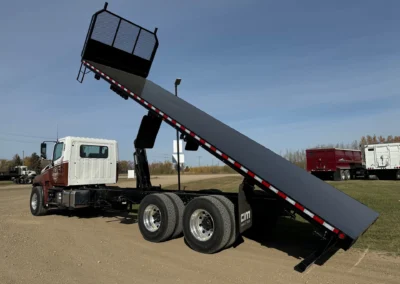 Heavy Duty Commercial Tag text: A commercial flat deck truck with the bed fully extended.