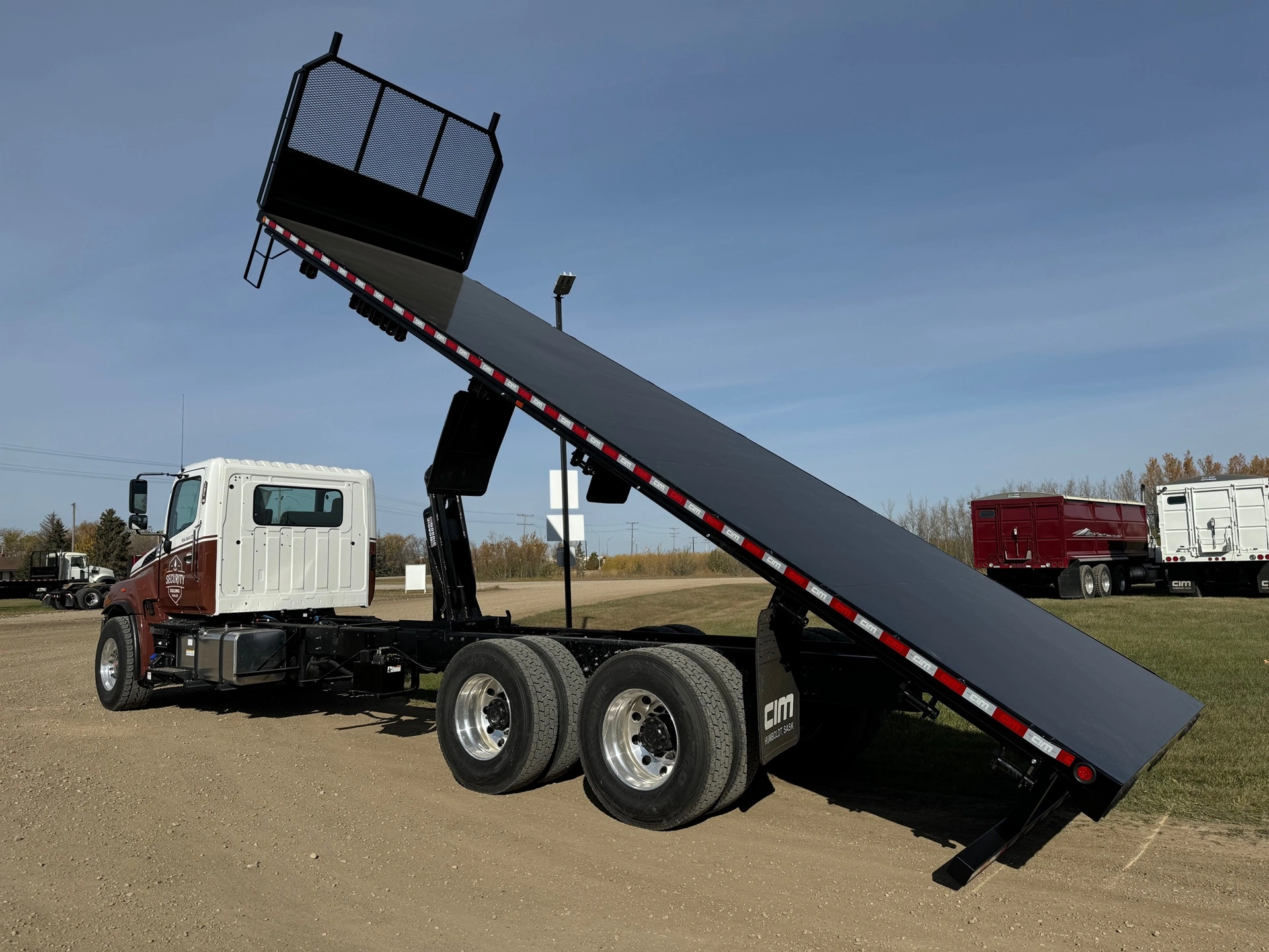 A commercial truck with it's deck raised all the way.
